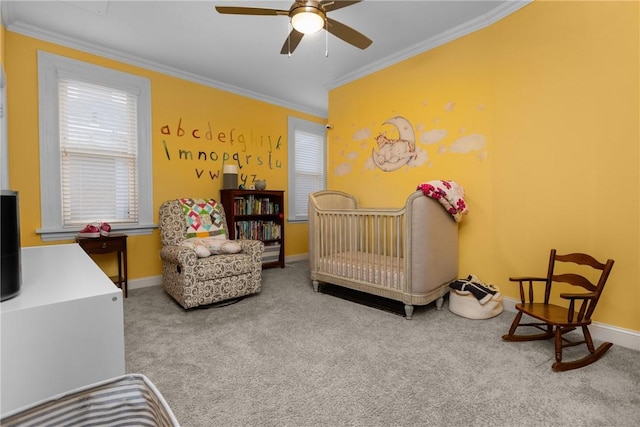 bedroom featuring ceiling fan, carpet, ornamental molding, and a crib