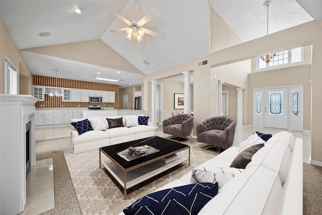 living room with high vaulted ceiling, ceiling fan, and ornate columns