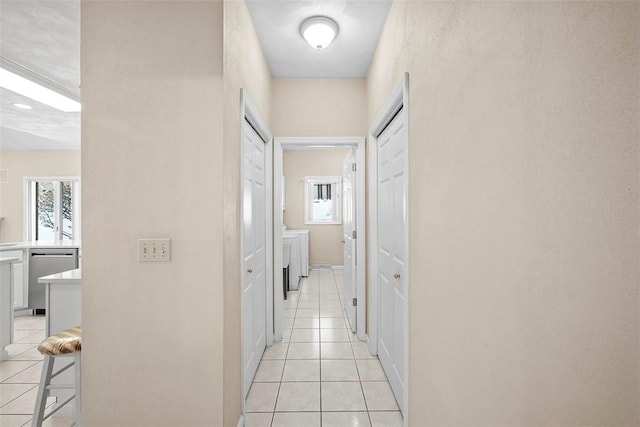 corridor featuring light tile patterned floors