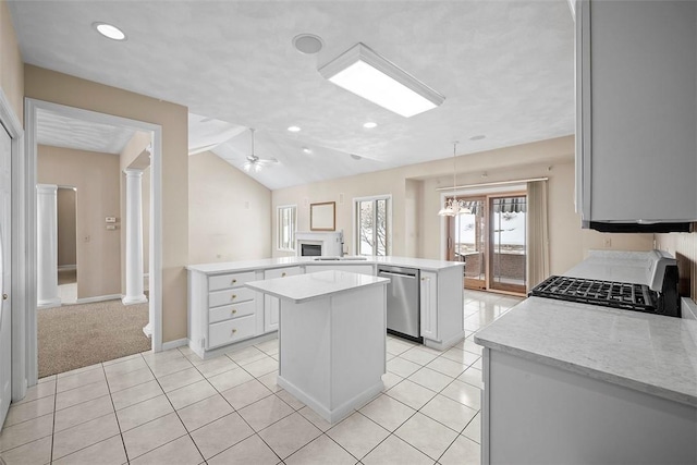 kitchen with ornate columns, range, dishwasher, kitchen peninsula, and vaulted ceiling