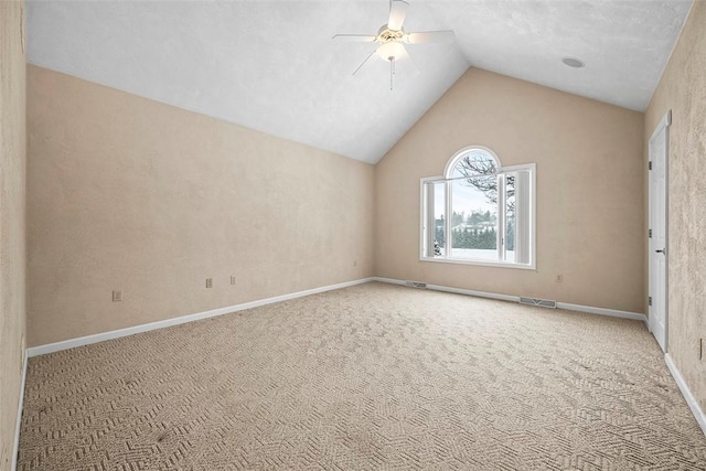 empty room featuring ceiling fan, light colored carpet, and lofted ceiling