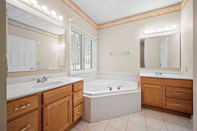 bathroom with tiled tub, tile patterned floors, and vanity