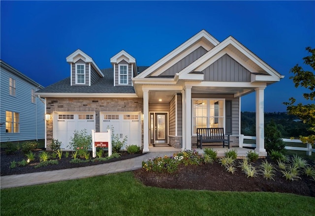 craftsman house featuring a porch and a garage