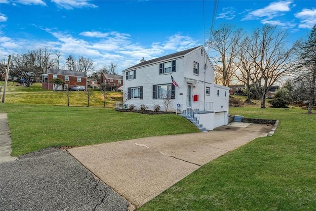 view of front of property with a garage and a front yard