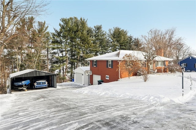 view of snowy exterior featuring a carport