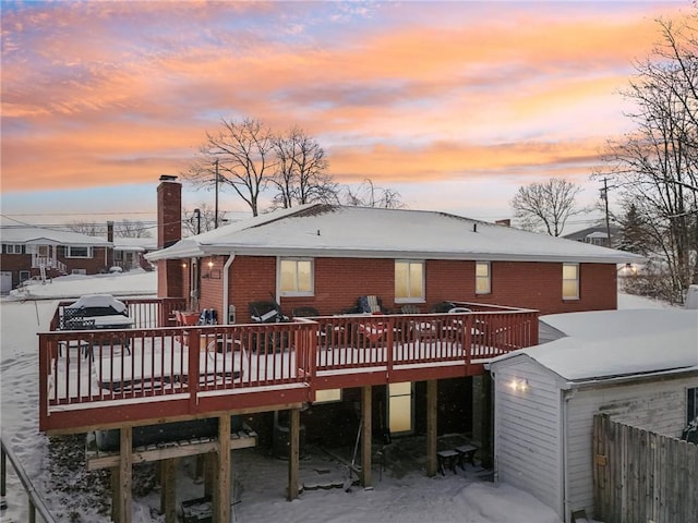 back house at dusk with a wooden deck