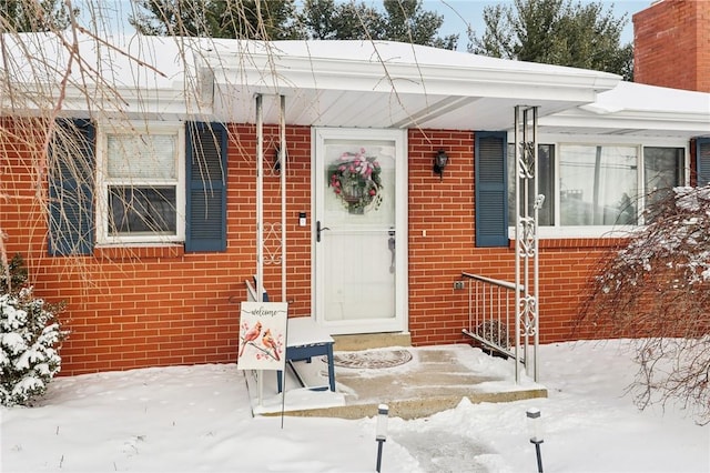 view of snow covered property entrance