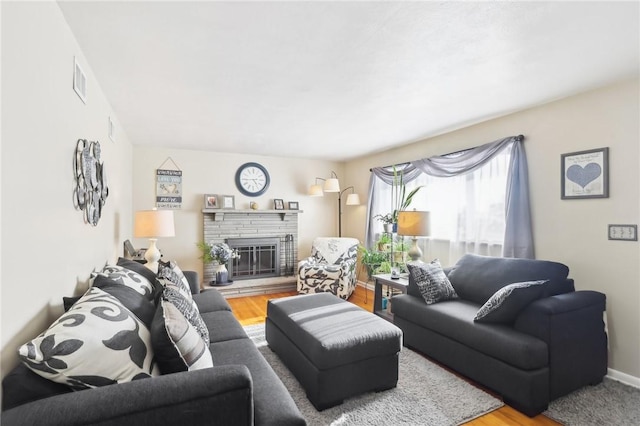 living room featuring a fireplace and wood-type flooring