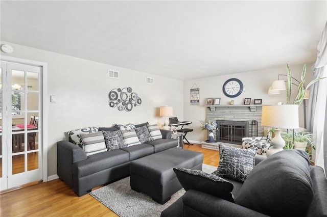 living room featuring wood-type flooring and a fireplace