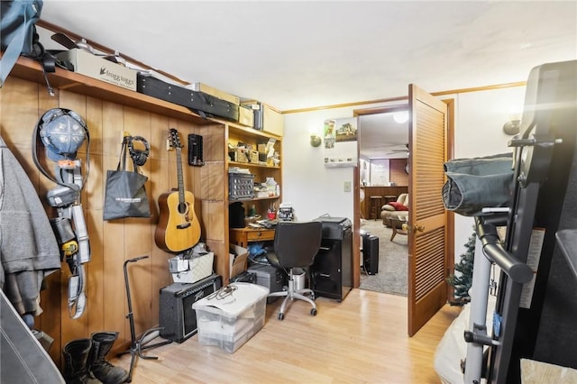 home office with crown molding and light hardwood / wood-style floors