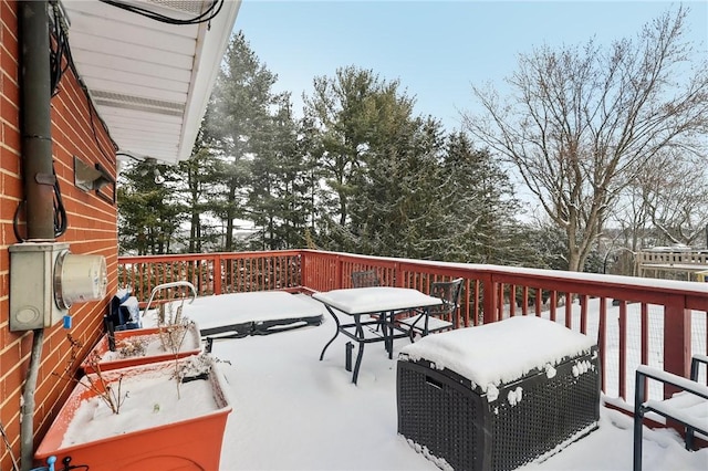 snow covered deck featuring a grill