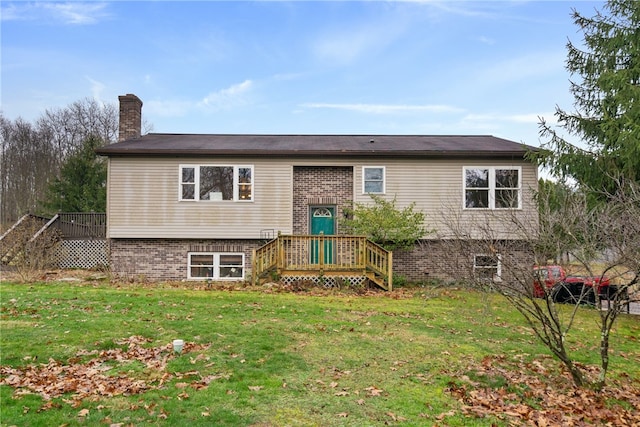 bi-level home featuring a wooden deck and a front lawn