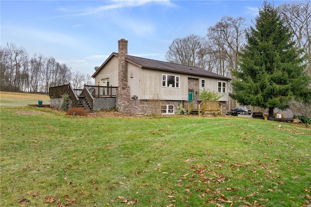 rear view of property with a lawn and a wooden deck