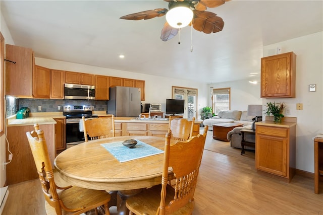 dining room featuring light hardwood / wood-style flooring and ceiling fan