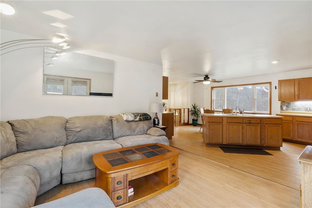 living room with sink and light hardwood / wood-style flooring