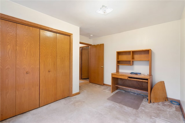 unfurnished office featuring light carpet