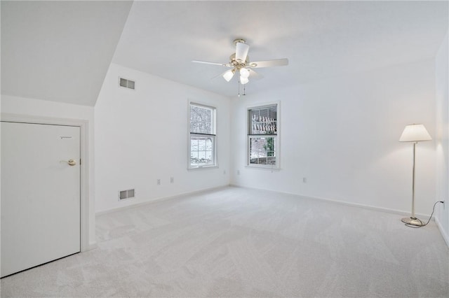 carpeted spare room featuring ceiling fan