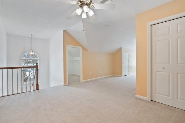 additional living space with ceiling fan, light colored carpet, and lofted ceiling