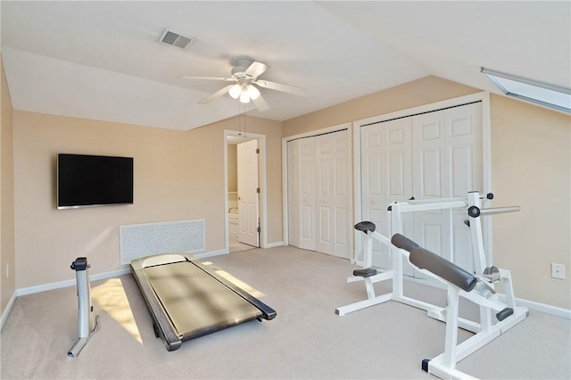 workout room featuring ceiling fan, light colored carpet, and lofted ceiling