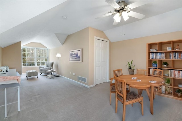 carpeted dining room featuring ceiling fan and lofted ceiling