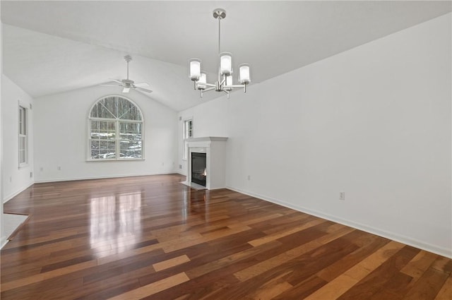 unfurnished living room featuring ceiling fan with notable chandelier, lofted ceiling, and dark hardwood / wood-style flooring