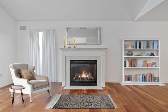 sitting room featuring hardwood / wood-style floors and vaulted ceiling