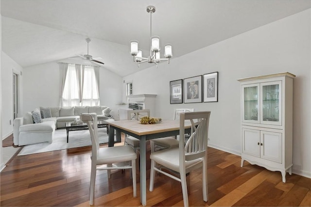 dining area with ceiling fan with notable chandelier, dark hardwood / wood-style floors, and lofted ceiling