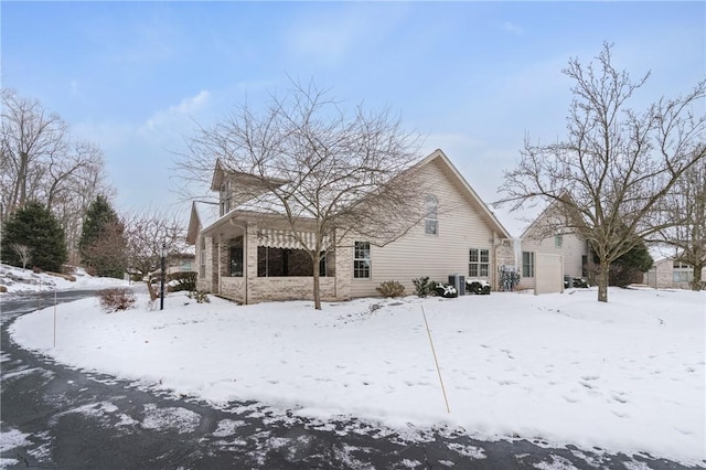 snow covered property featuring central air condition unit