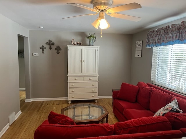 living room featuring ceiling fan and light hardwood / wood-style floors