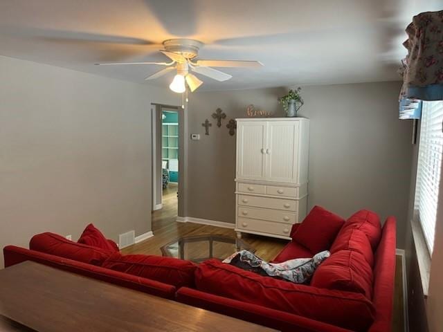 living room with ceiling fan, hardwood / wood-style flooring, and a healthy amount of sunlight