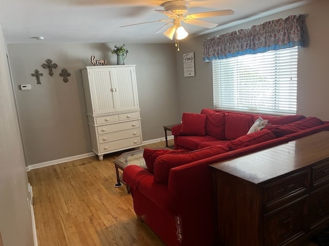 living room featuring ceiling fan and light wood-type flooring