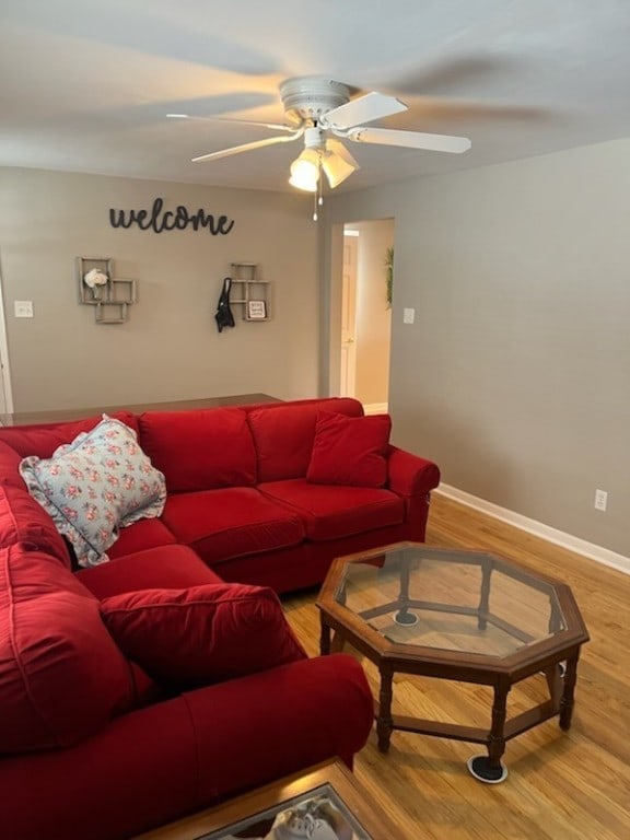 living room featuring hardwood / wood-style floors and ceiling fan