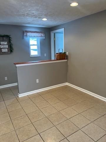 spare room featuring light tile patterned flooring