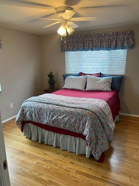 bedroom with ceiling fan and light hardwood / wood-style floors