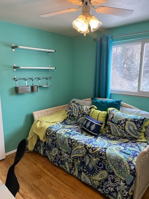 bedroom featuring hardwood / wood-style flooring and ceiling fan