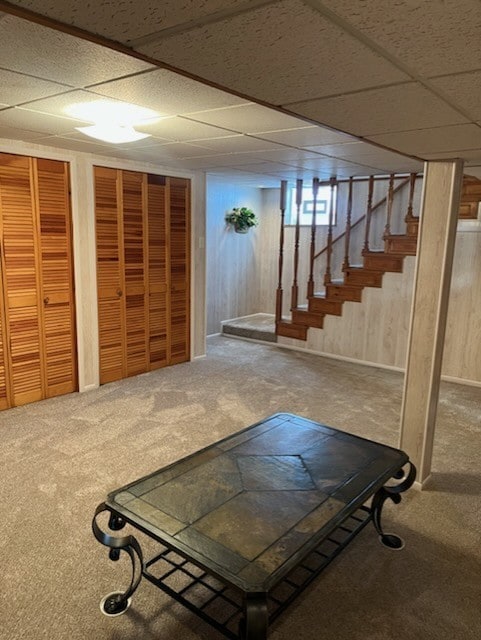 workout area featuring carpet floors and a drop ceiling