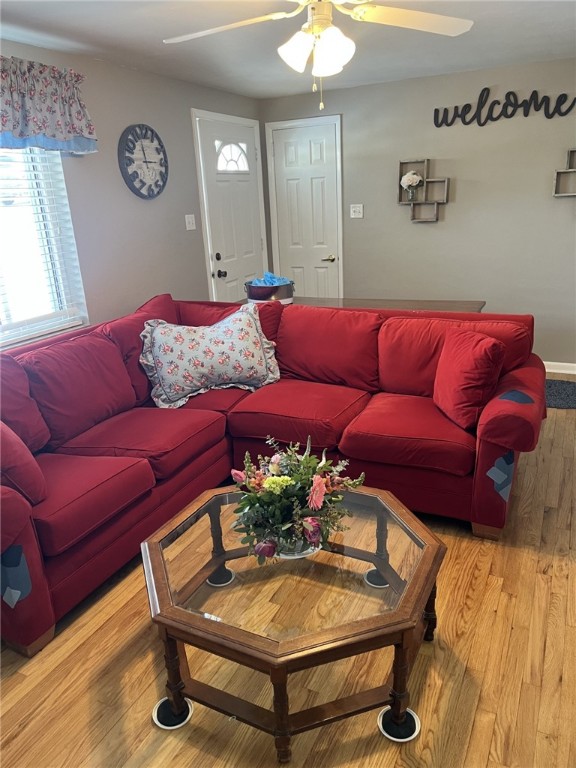 living room featuring hardwood / wood-style flooring and ceiling fan