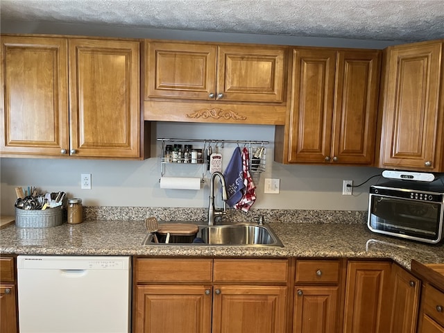 kitchen featuring sink, a textured ceiling, and white dishwasher