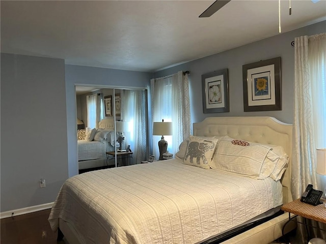 bedroom with wood-type flooring, a closet, and ceiling fan