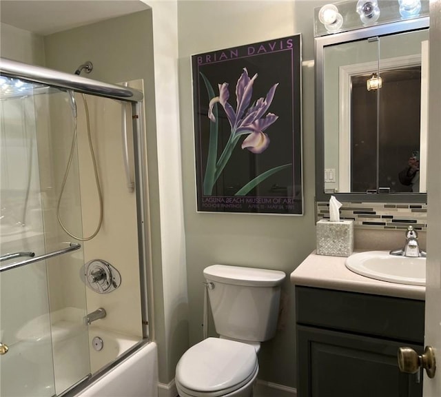 full bathroom featuring combined bath / shower with glass door, backsplash, toilet, and vanity