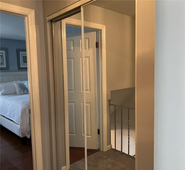 hallway with dark colored carpet