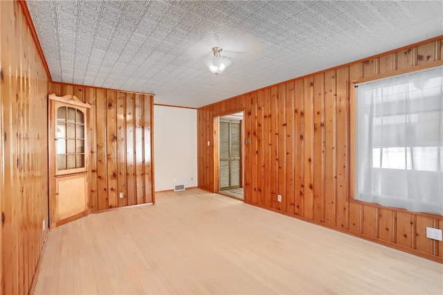 unfurnished room with wood-type flooring and ornamental molding