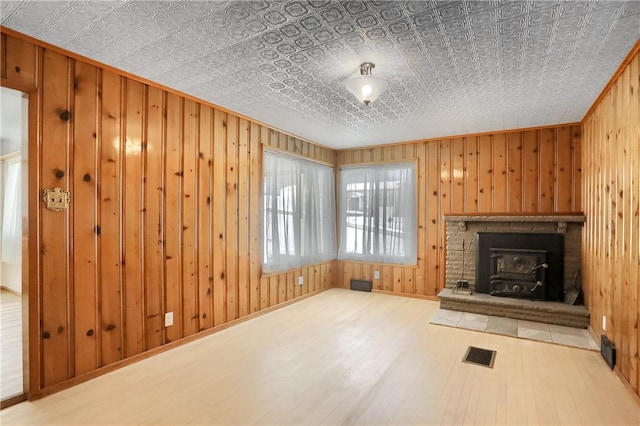 unfurnished living room featuring hardwood / wood-style flooring and wood walls