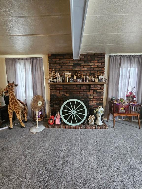 carpeted living room with a fireplace