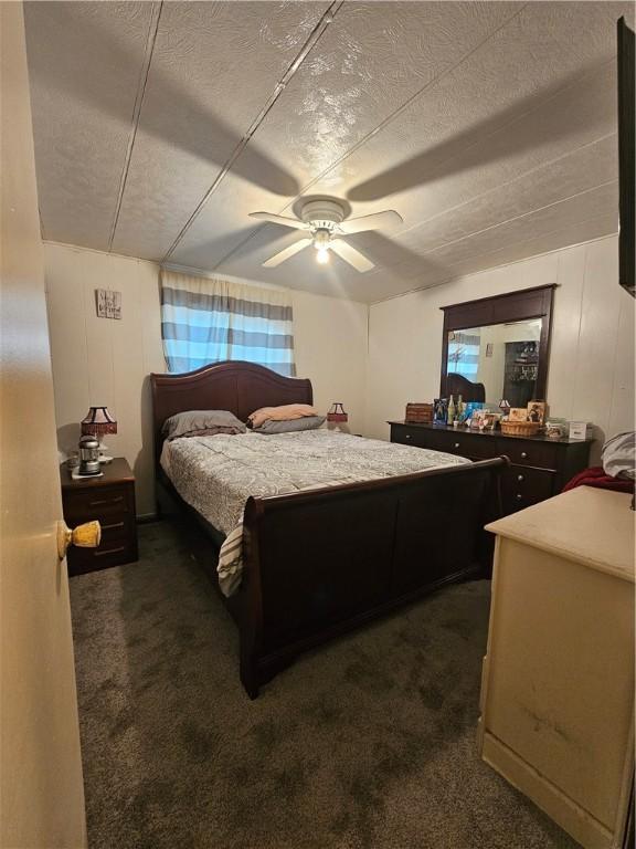 carpeted bedroom with a textured ceiling and ceiling fan