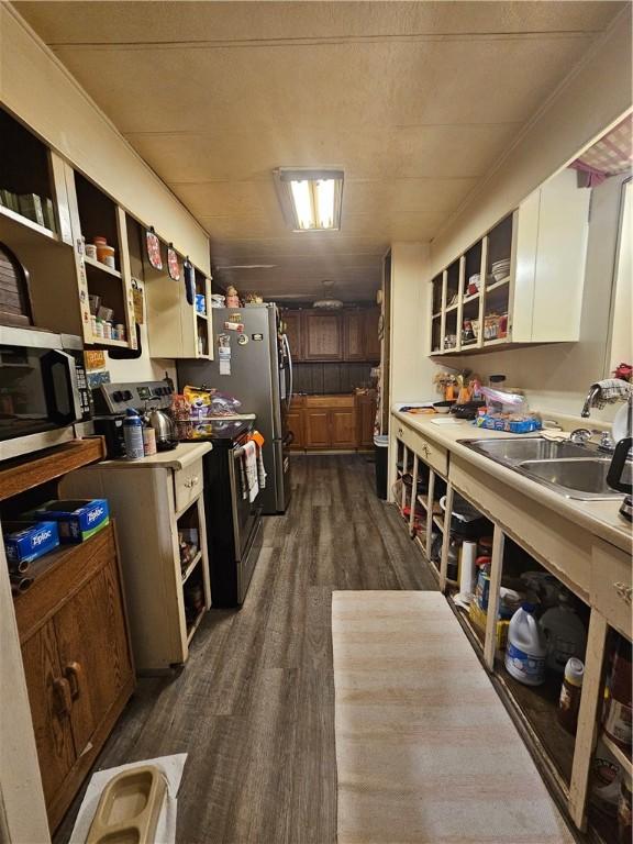 kitchen featuring white cabinets, stainless steel appliances, dark wood-type flooring, and sink