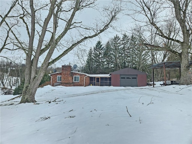 exterior space featuring a garage and an outbuilding