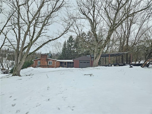 snowy yard with a garage