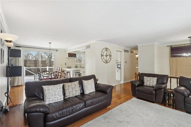 living room featuring hardwood / wood-style flooring and ornamental molding