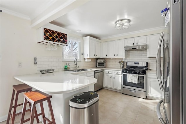 kitchen with white cabinetry, stainless steel appliances, crown molding, and kitchen peninsula